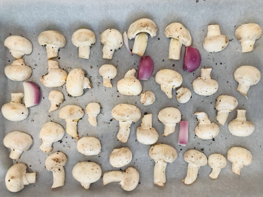 baked white mushrooms on a baking sheet up to 350F.